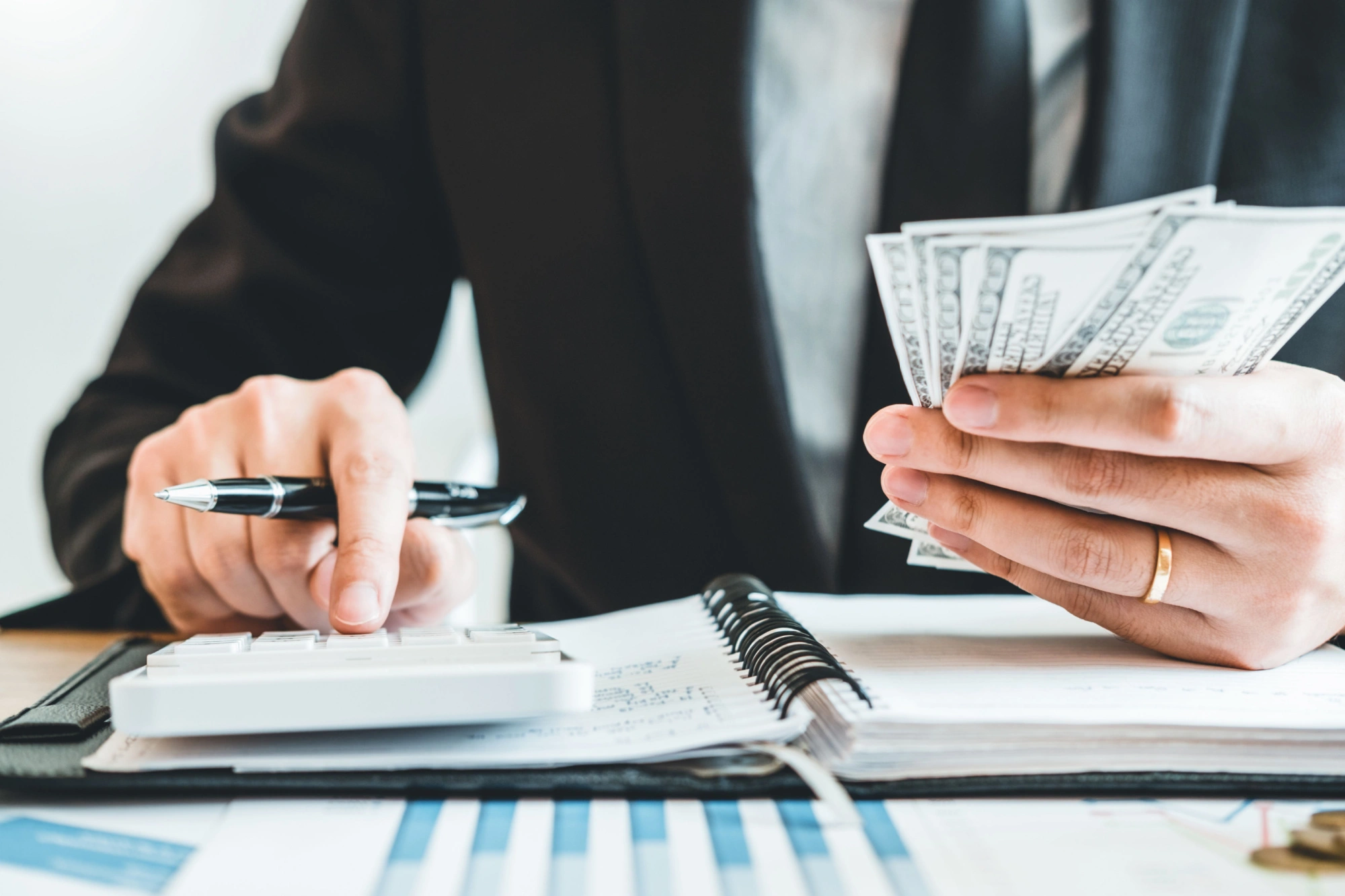 Businessman counting 100 dollar bills