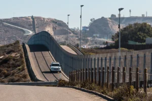 Border patrol car driving along the Mexican border