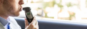 A motorist taking a breathalyzer test