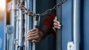 A woman inside a locked cargo container