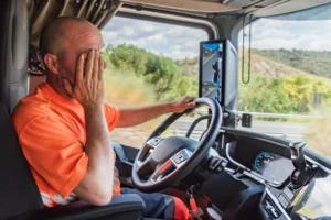 A commercial truck driver experiencing fatigue