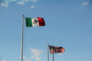 A Mexican flag and an American flag