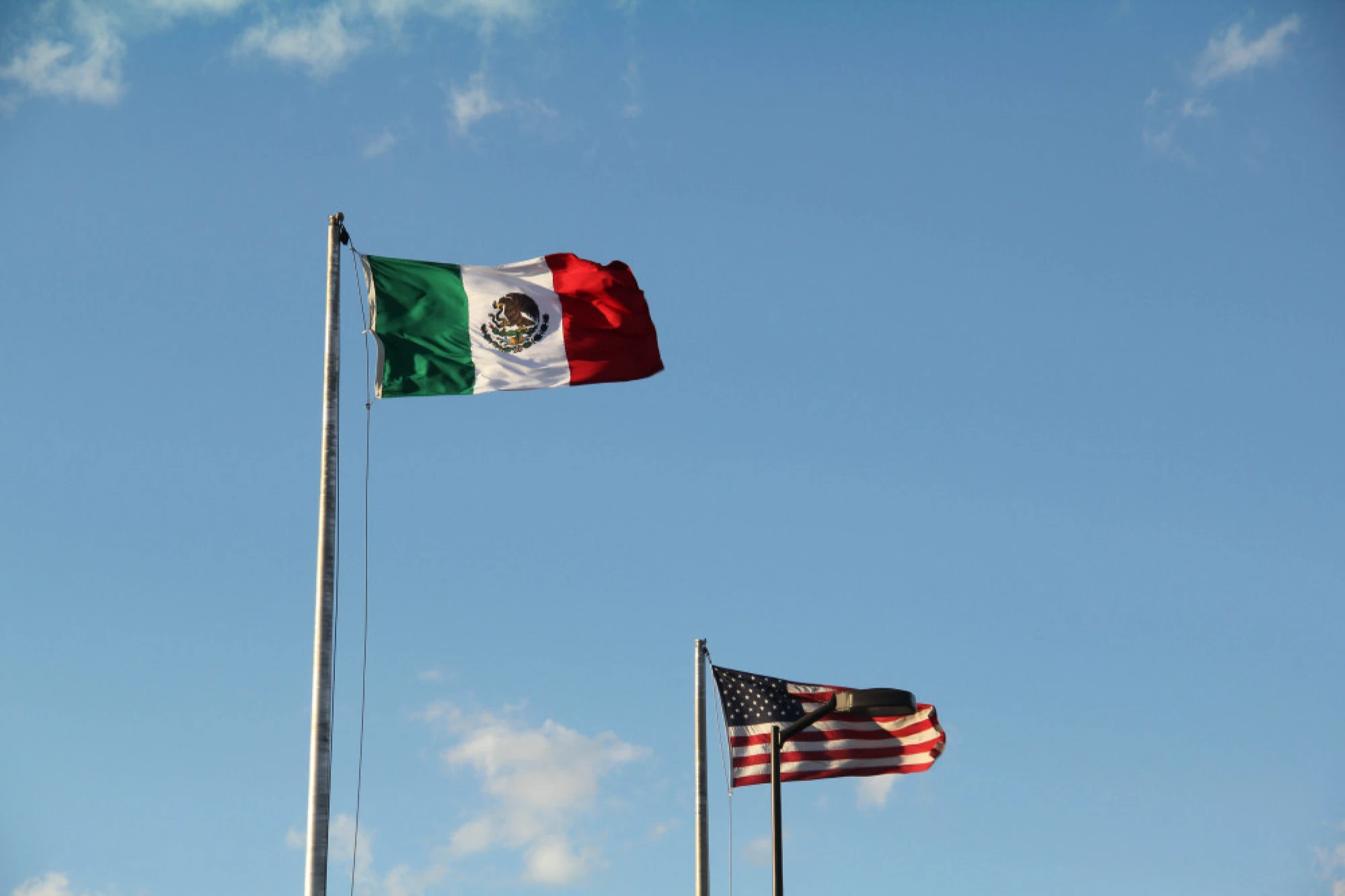 A Mexican flag and an American flag