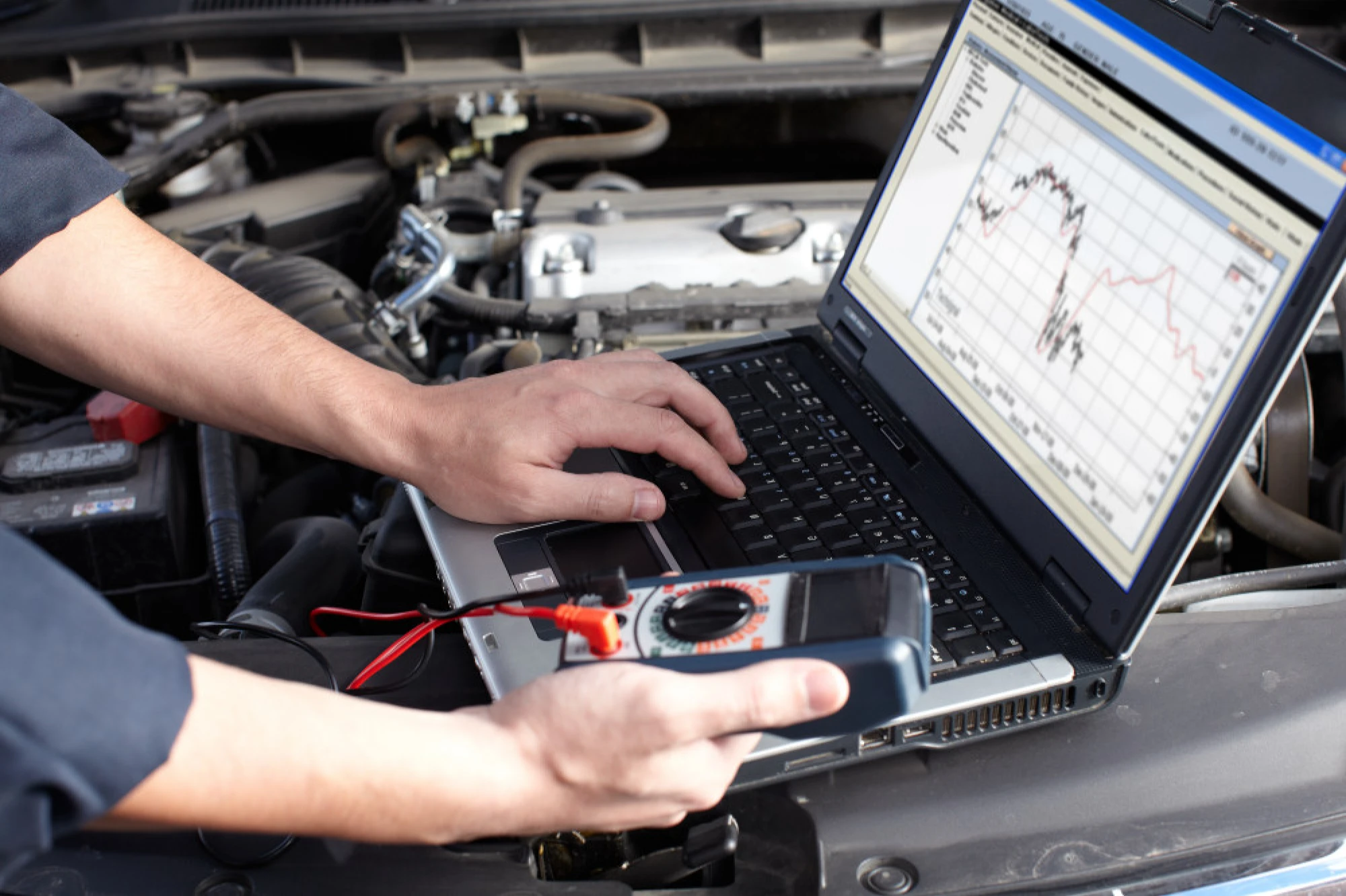 A mechanic reviewing data from a vehicle’s onboard computer