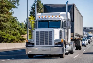 Semi truck driving on the freeway.