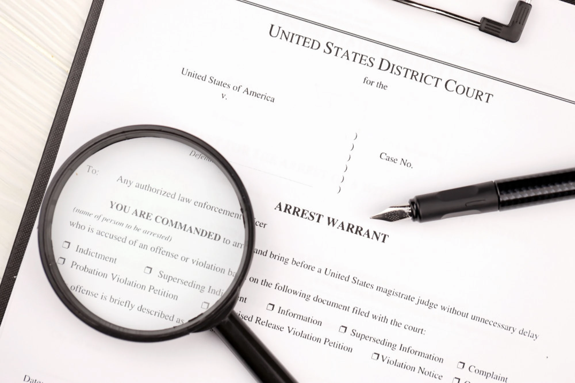 A close-up view of a Federal arrest warrant.