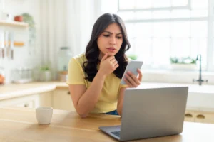 A young woman on the phone with an insurance claims adjuster