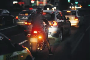 A motorcyclist waiting in traffic with other motorists