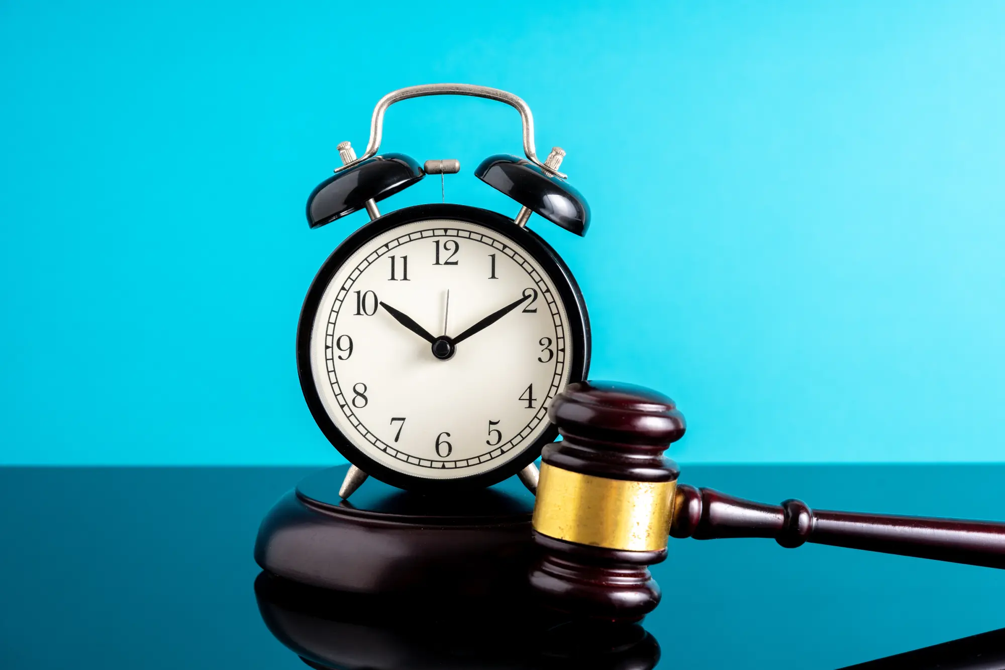 A judge’s gavel and an alarm clock symbolizing the statute of limitations