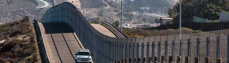 Border patrol car driving along the Mexican border