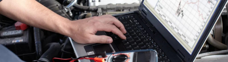 A mechanic reviewing data from a vehicle’s onboard computer