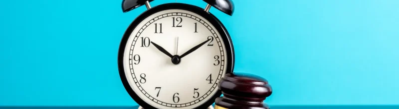 A judge’s gavel and an alarm clock symbolizing the statute of limitations