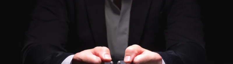 Handcuffed hands on an interrogation table