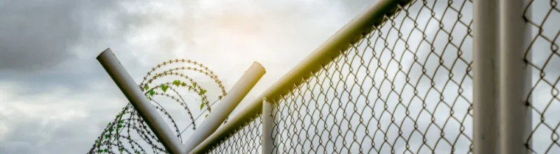 A border security fence with razor wire