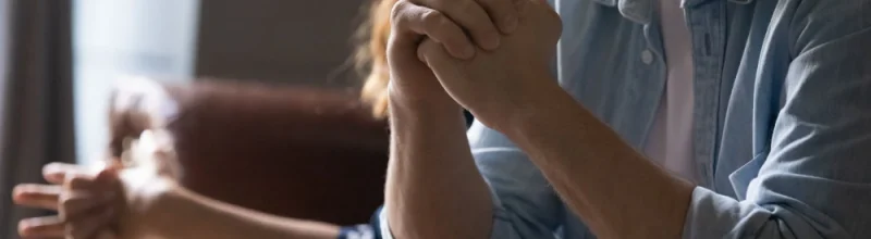 Unhappy married couple sitting on the couch