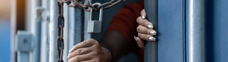 A woman inside a locked cargo container