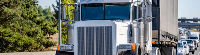 Semi truck driving on the freeway.