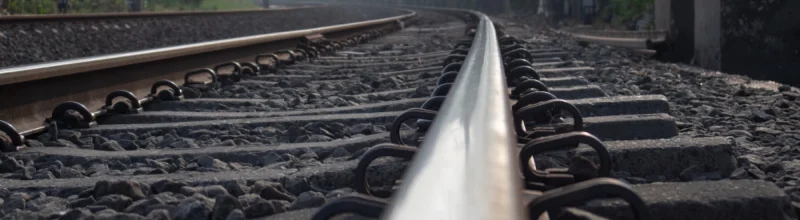 Railroad tracks leading into a city