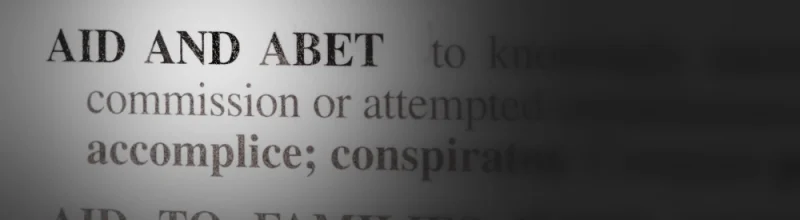 close of view of the dictionary definition of aid and abet