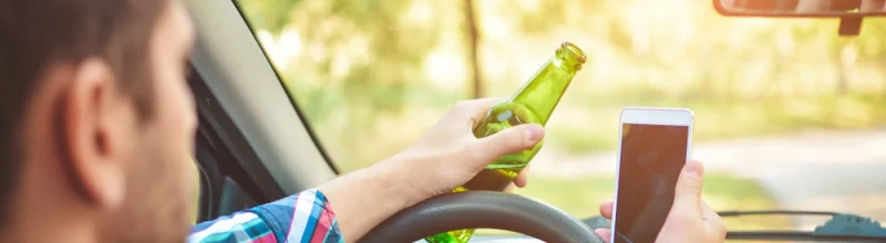 A man texting while drunk driving